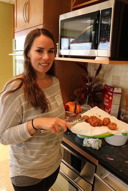 Blog author showing off a plate of corn-breaded nuggets