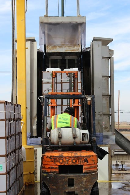 A forklift loading produce boxes into a cooling facility