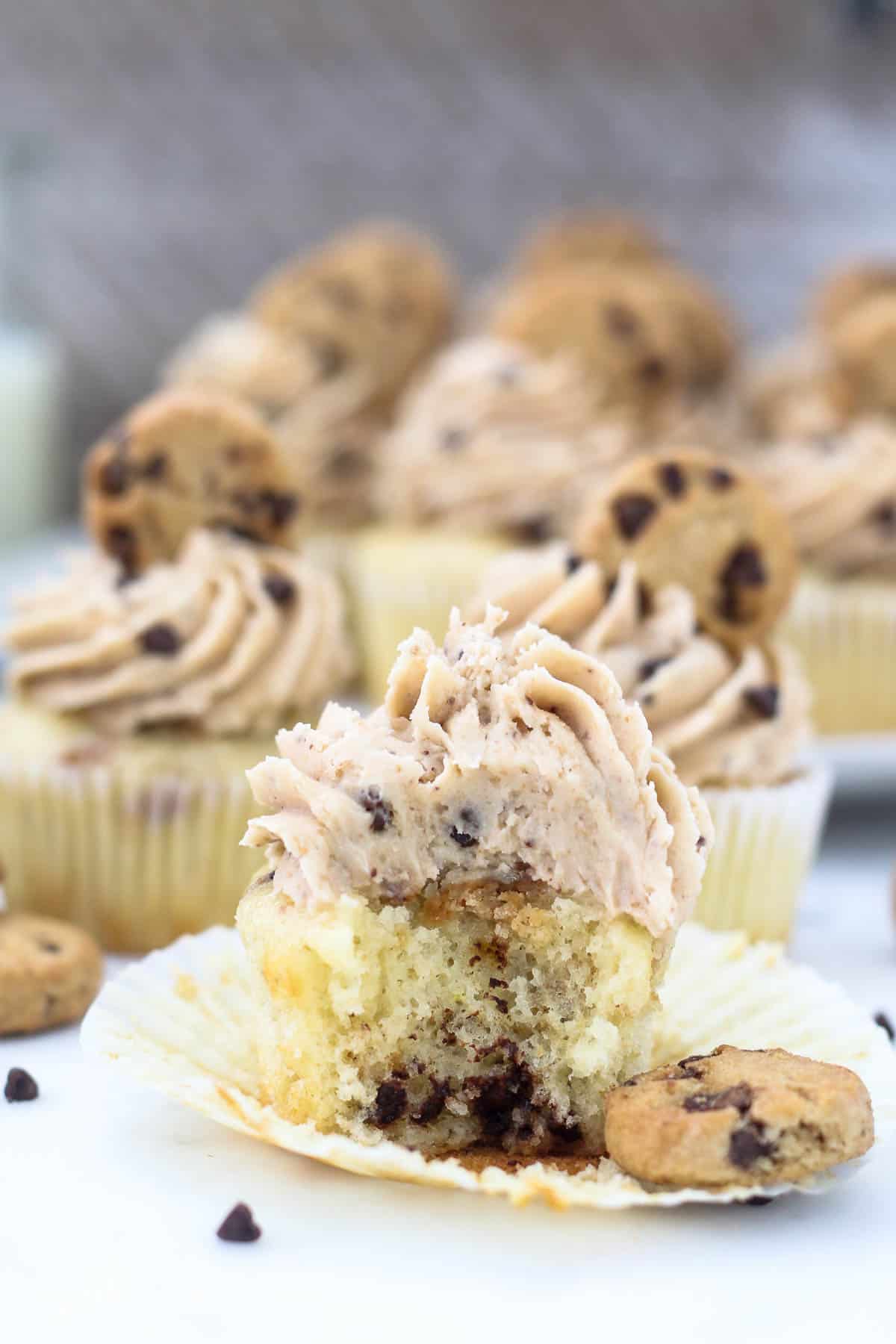 A chocolate chip cupcake with a bite missing to show the inside