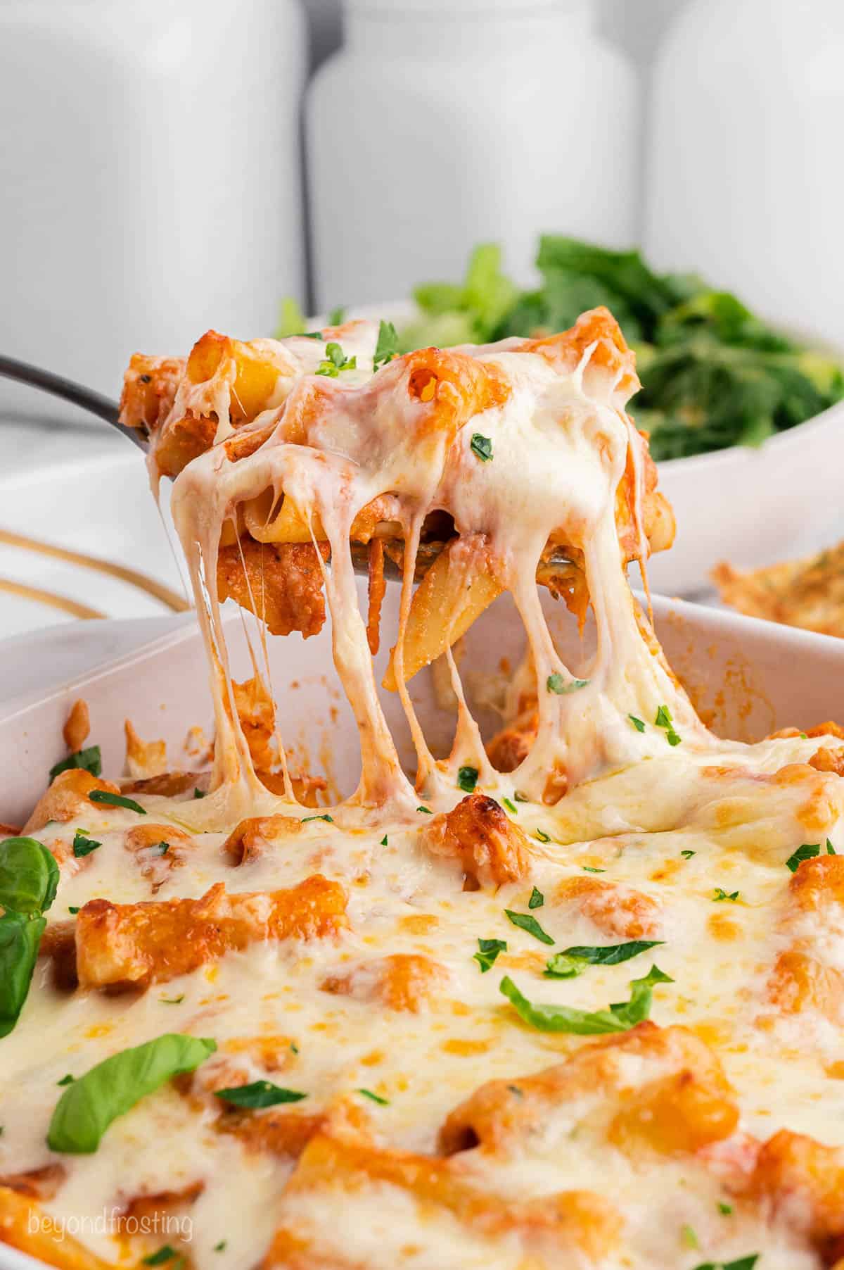 A spoon serving baked ziti