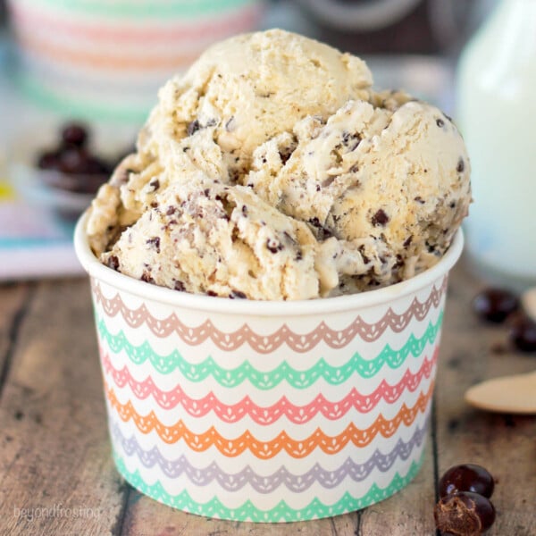 Scoops of coffee ice cream in a paper cup.