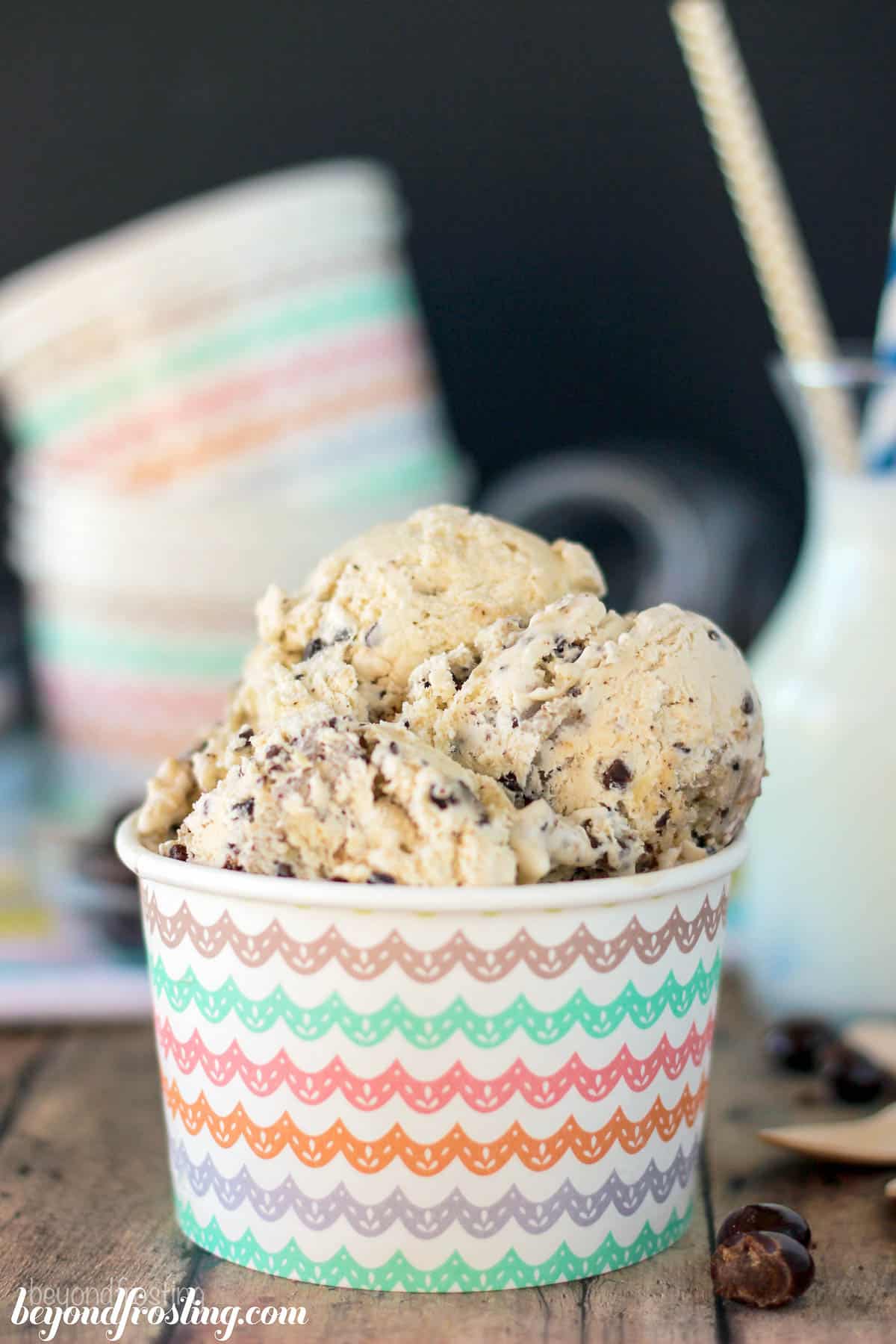 side view of a container piled with scoops of cookie dough ice cream