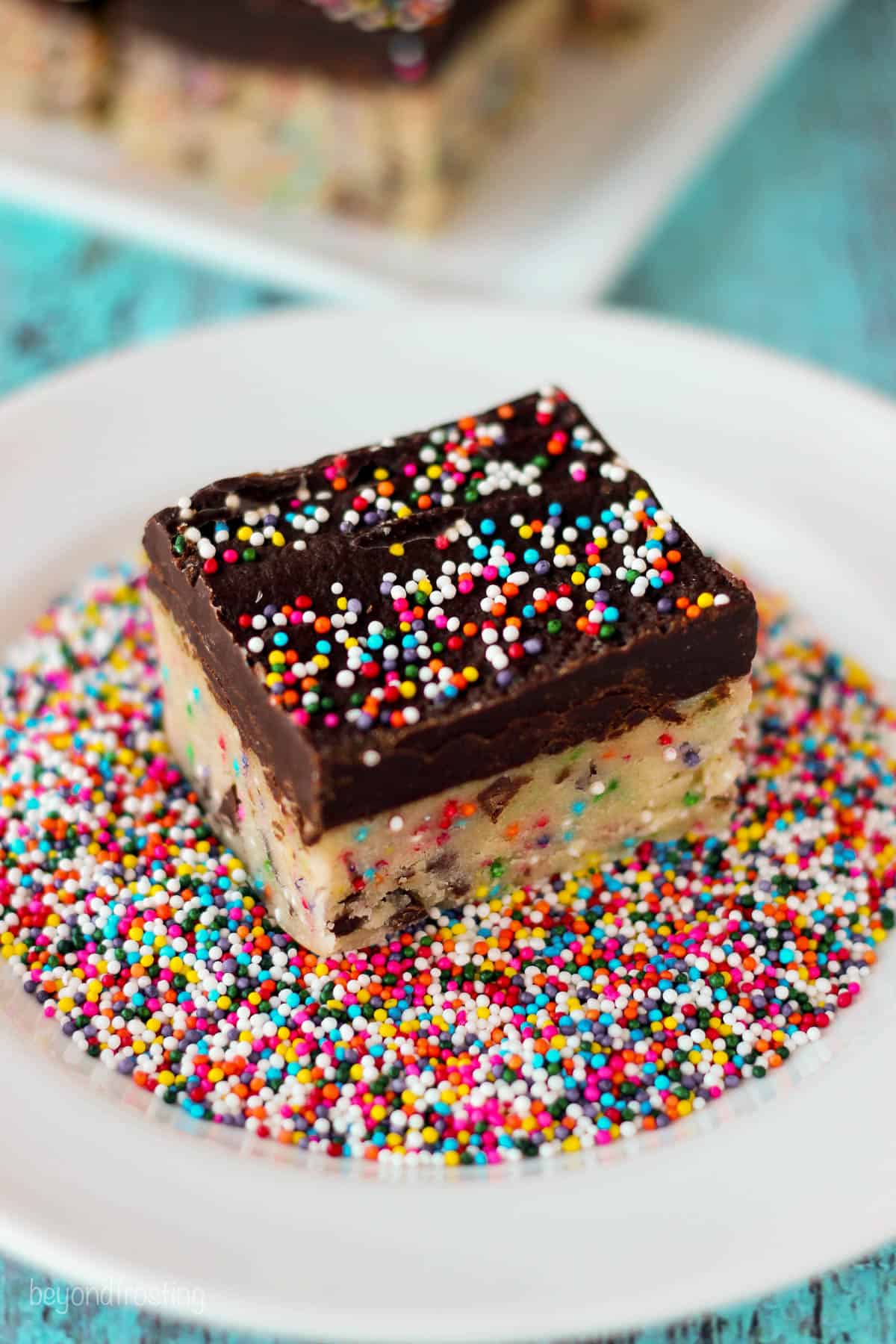 overhead of a cookie dough truffle bar set in a bowl full of sprinkles