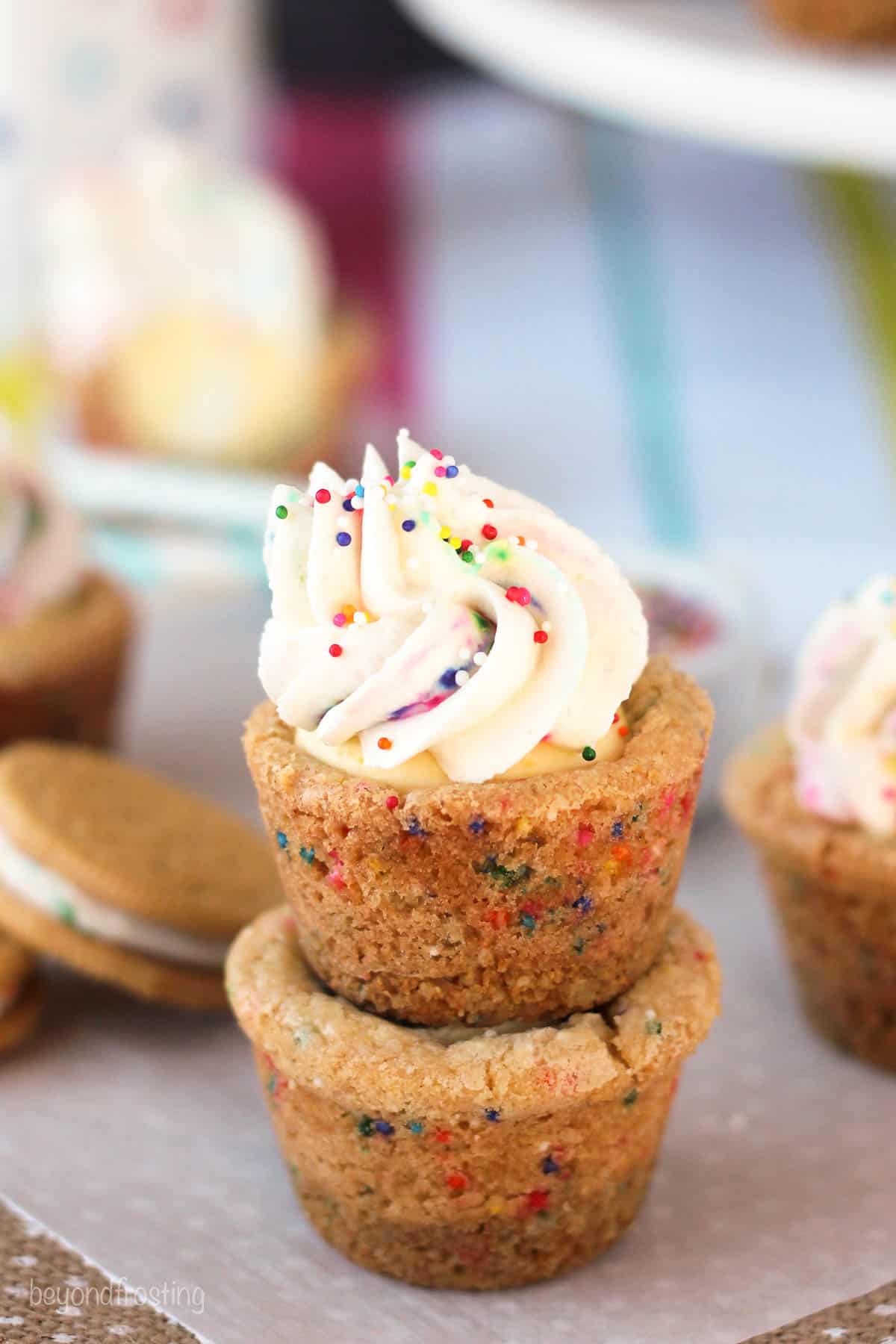 side view of two cookie cups stacked with frosting on the top