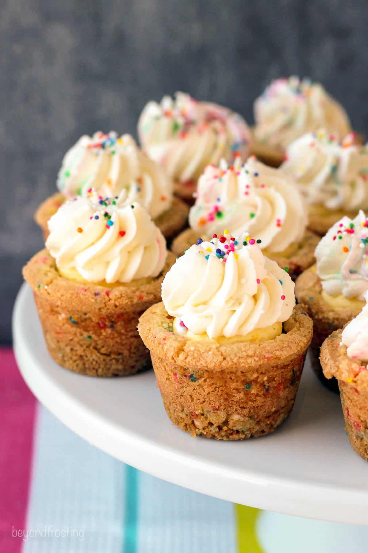 side view of a cake stand filled with funfetti cream pie cookie cups