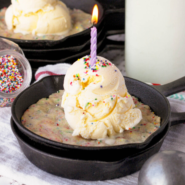 side view of a funfetti skillet cookie topped with ice cream and sprinkles
