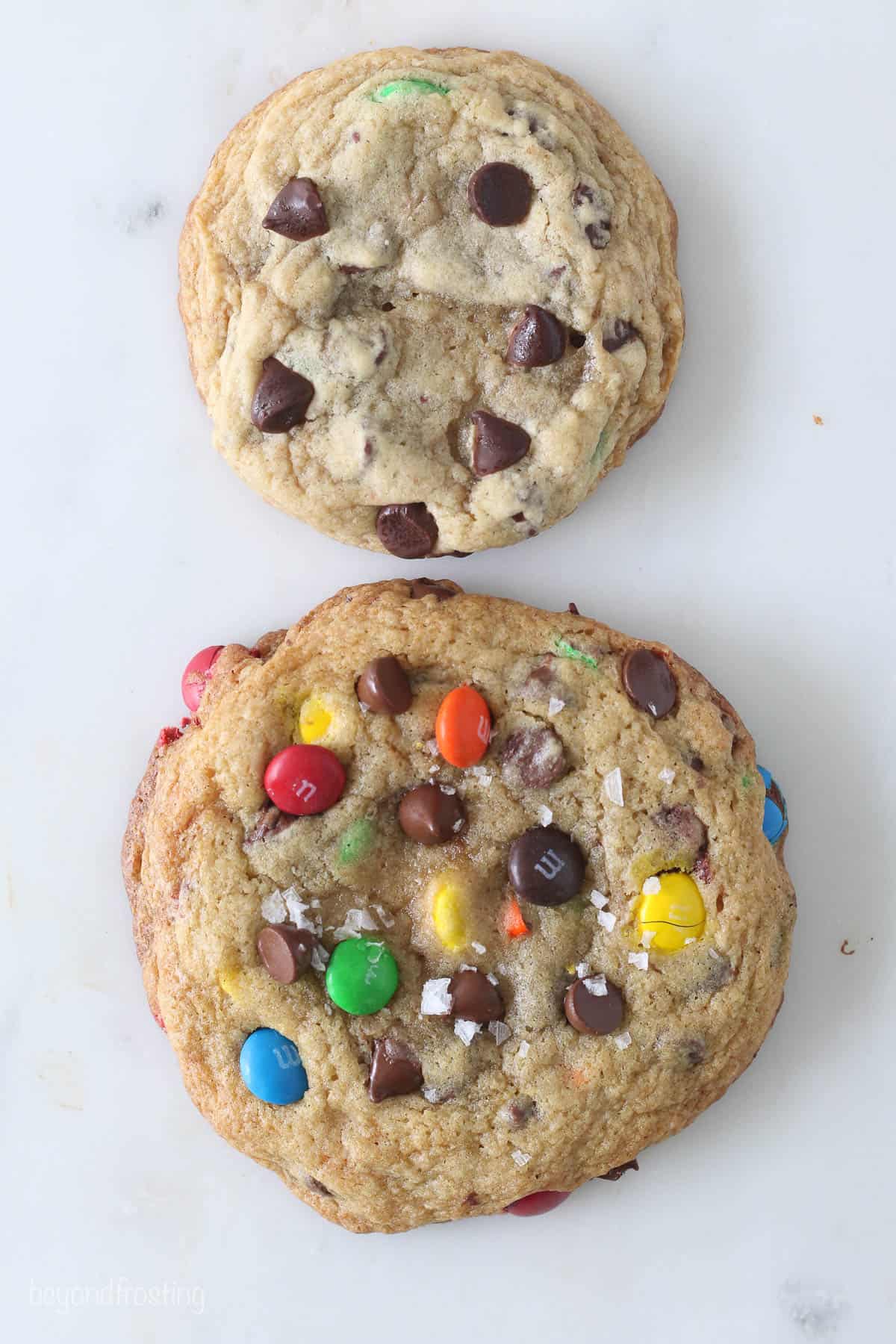 A giant and regular sized chocolate chip M&M cookie