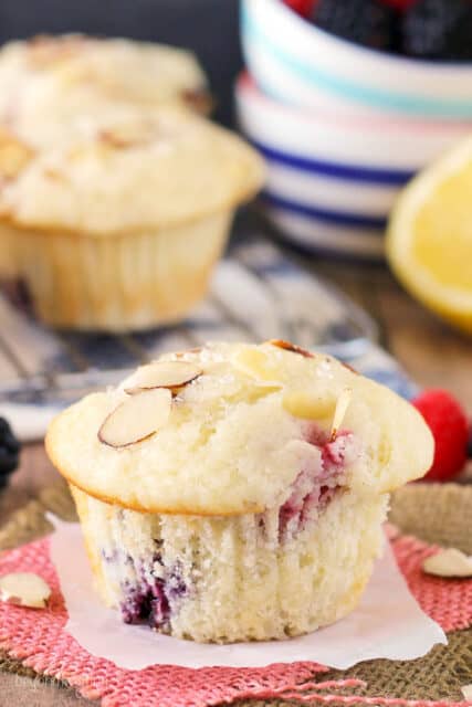 side view of a lemon raspberry muffin with more muffins in the background