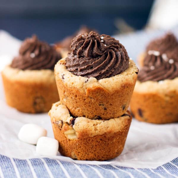 two graham cracker cookie cups stacked with frosting on the top