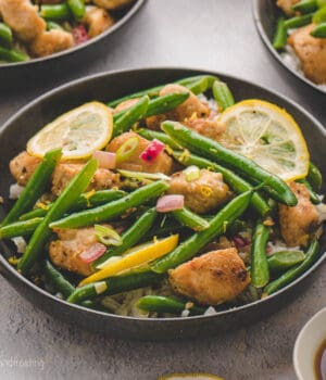 A bowl of lemon chicken and green beans stir fry