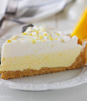 closeup side view of a slice of ice cream pie topped with lemon zest