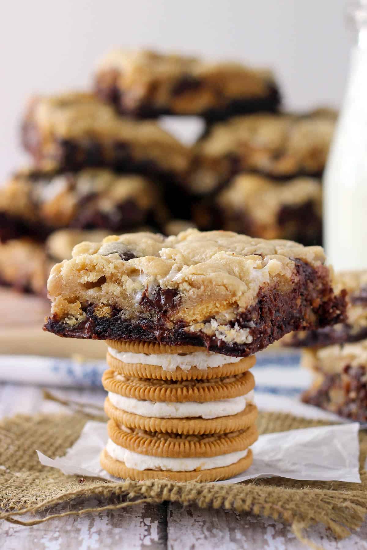 three golden oreos stacked with a marshmallow oreo brookie set on top