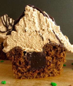 closeup of a cupcake sliced in half to show a chocolate filling