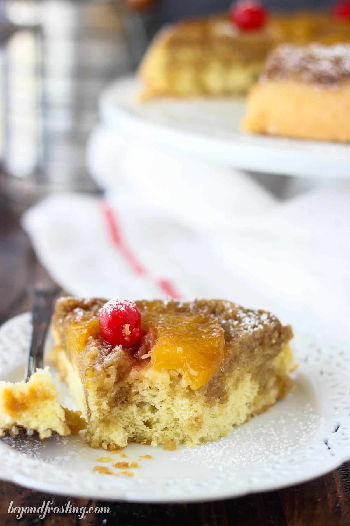 a half eaten slice of pineapple cake on a white plate