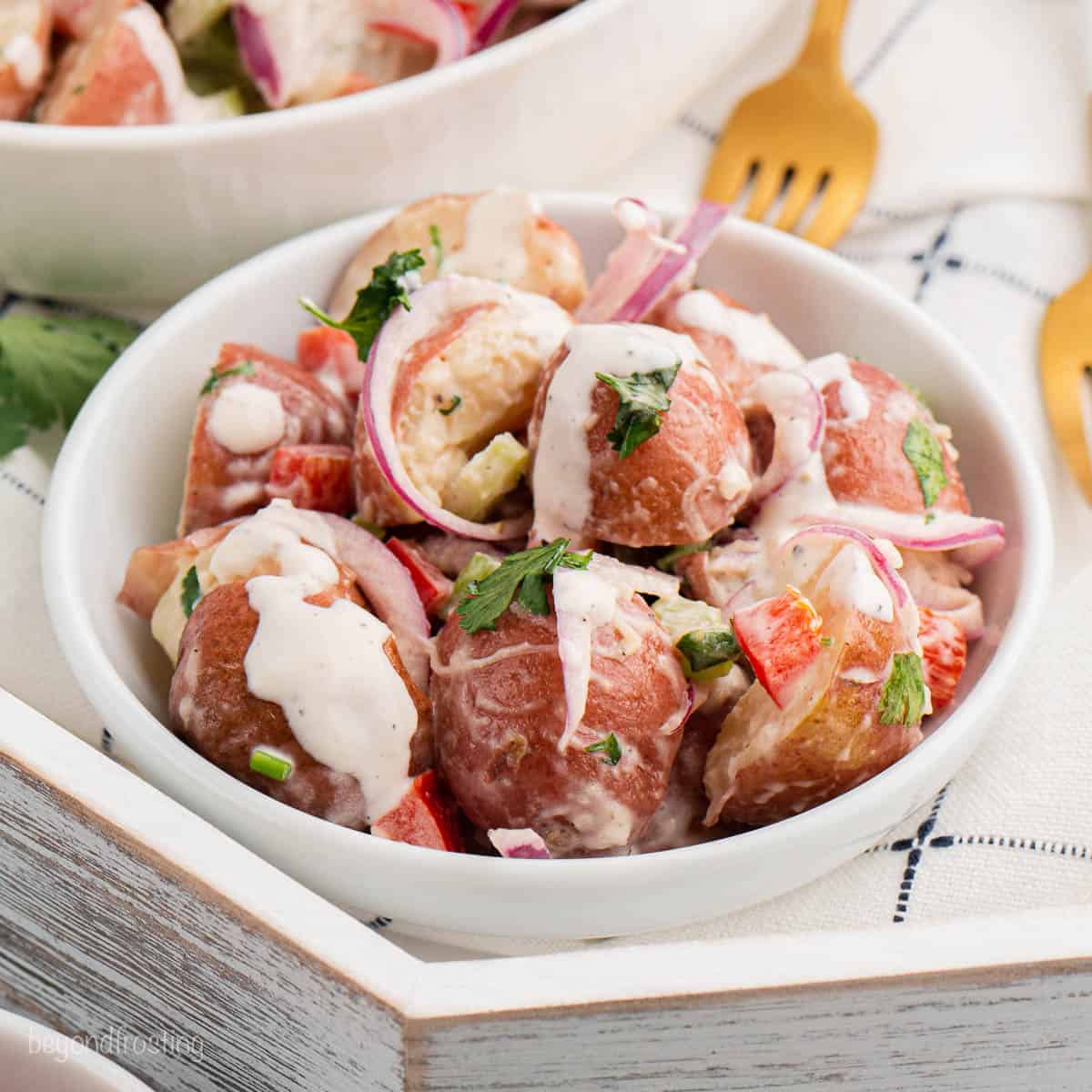 Angled view of a bowl of red potato salad