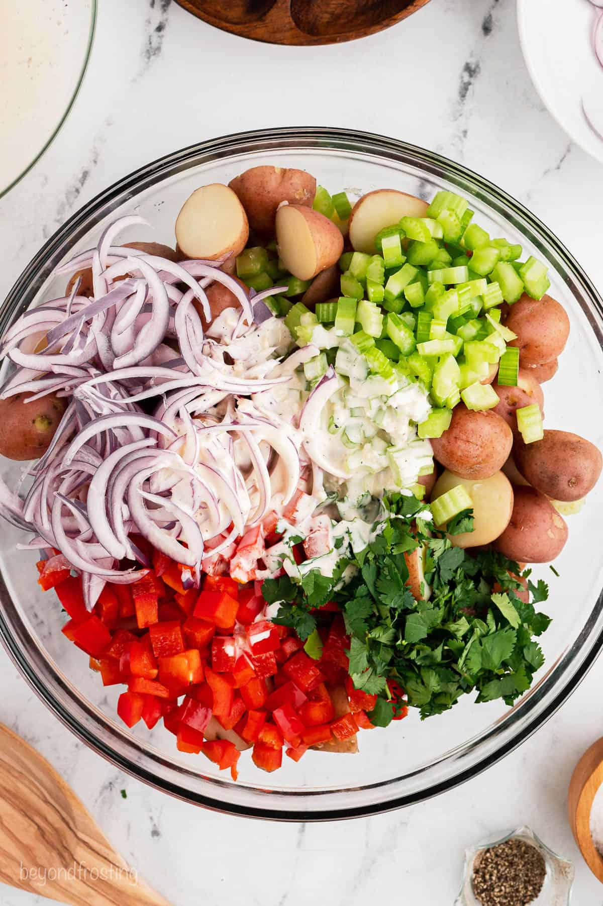Red potato salad ingredients in a mixing bowl