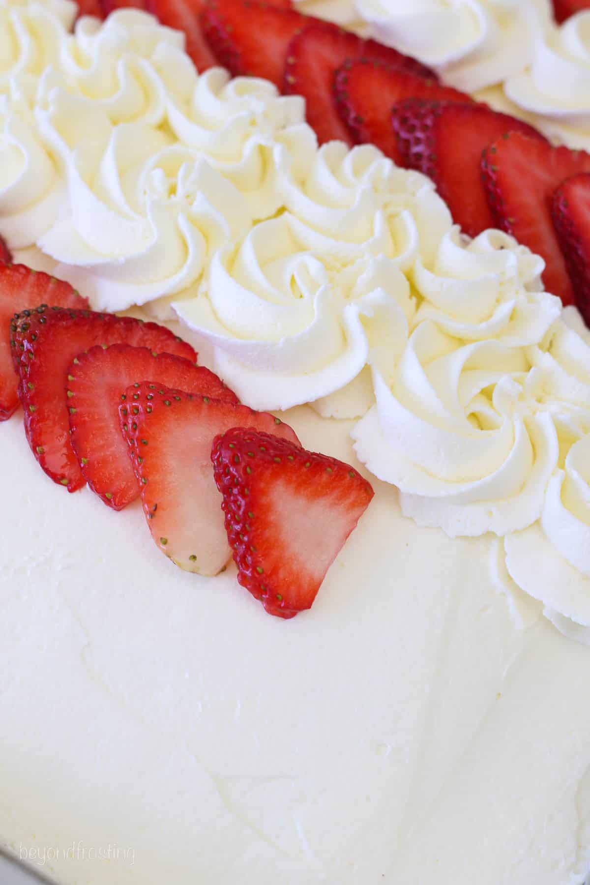 Step by step photo for decorating a flag cake with strawberries and whipped cream