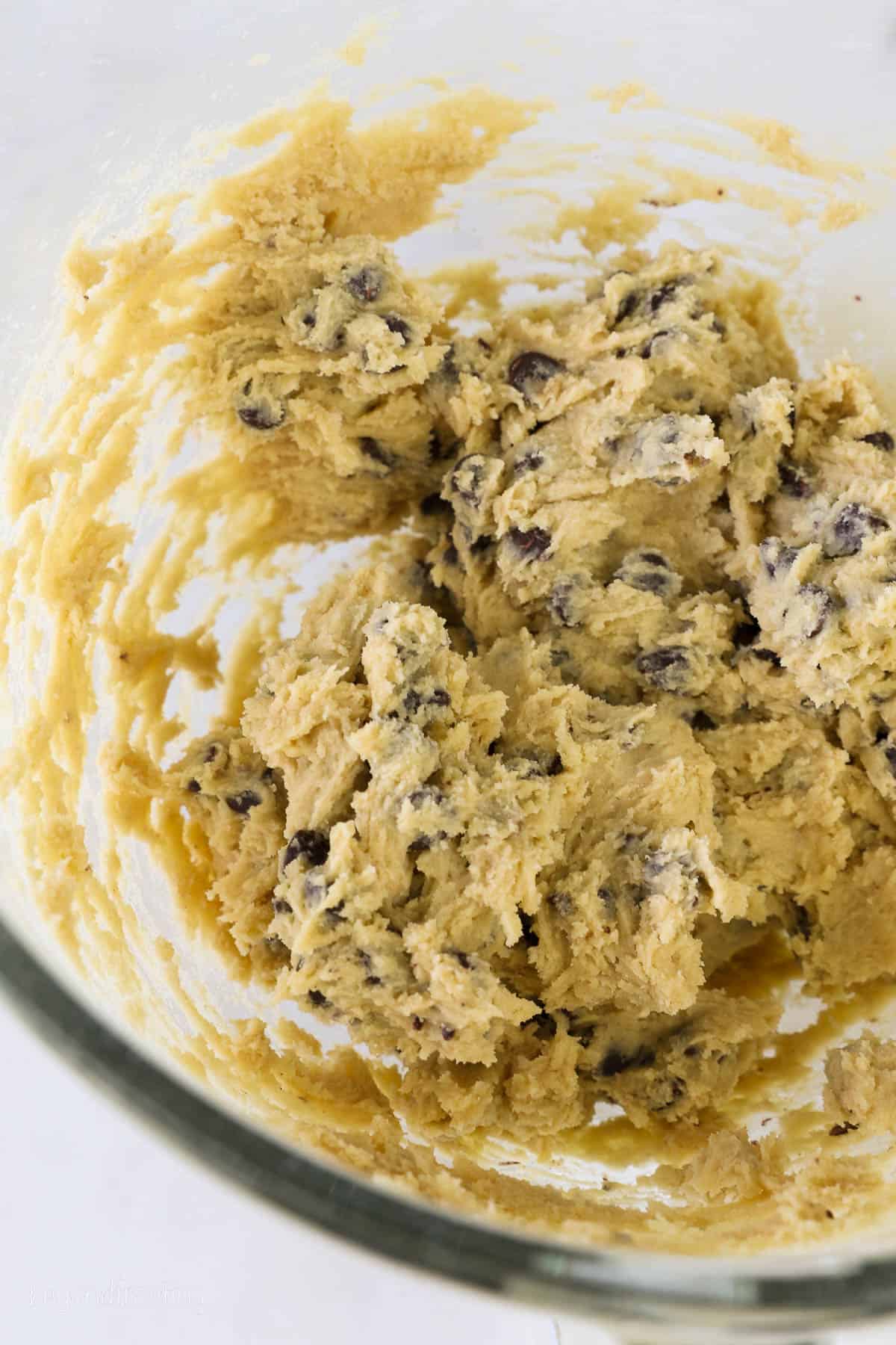 a glass mixing bowl of cookie dough