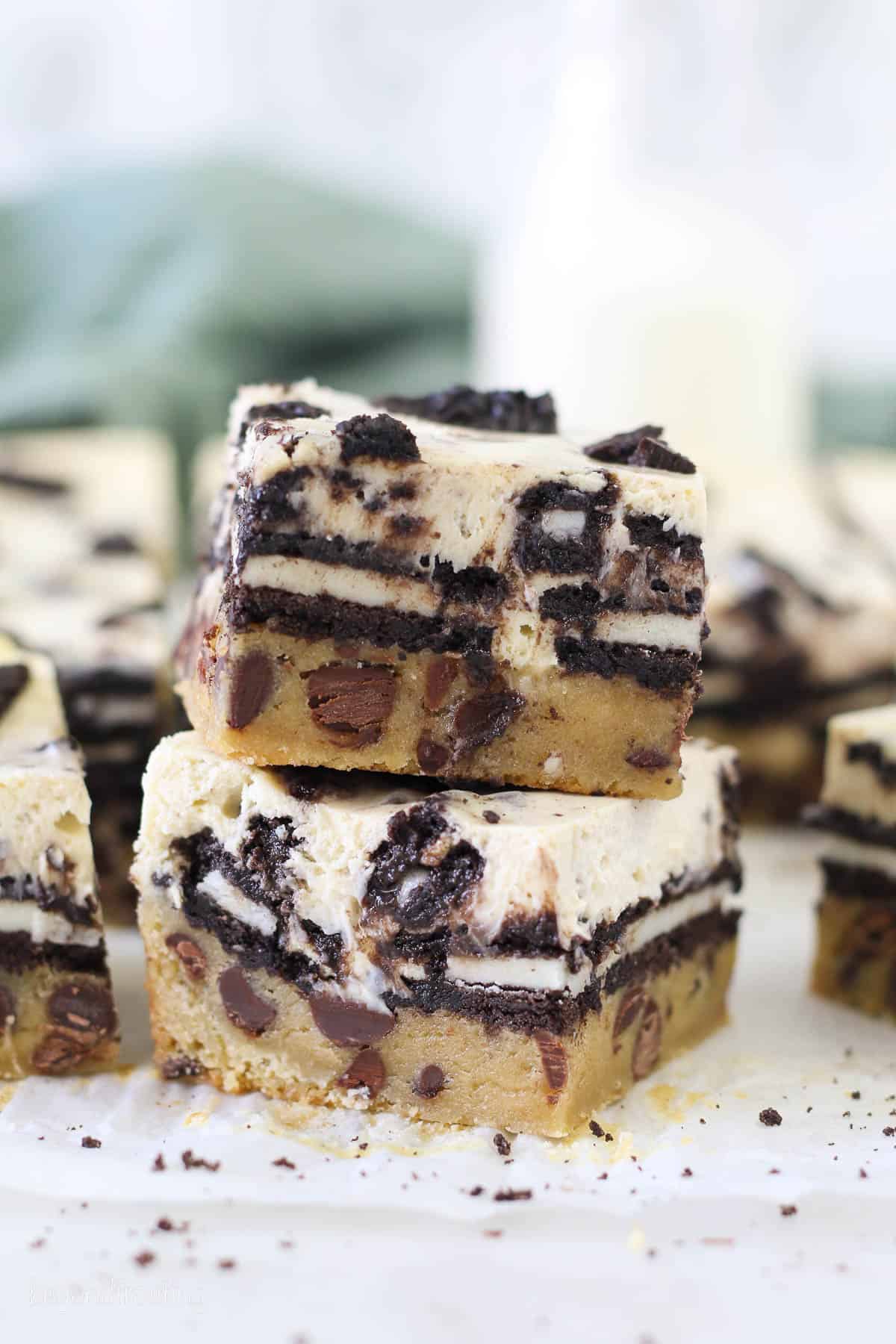 Two stacked Slutty Cheesecake Bars showing the layers of the bars