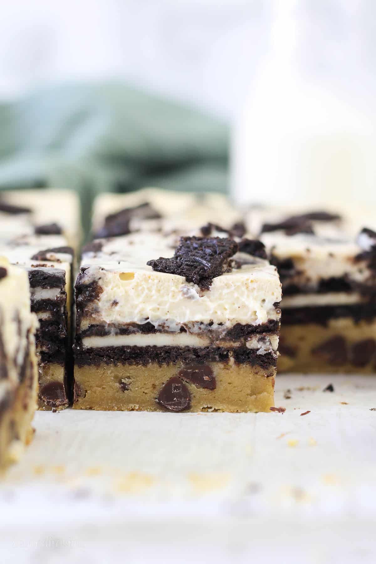 A layered cheesecake bar with chocolate chip cookies, Oreos and Oreo cheesecake