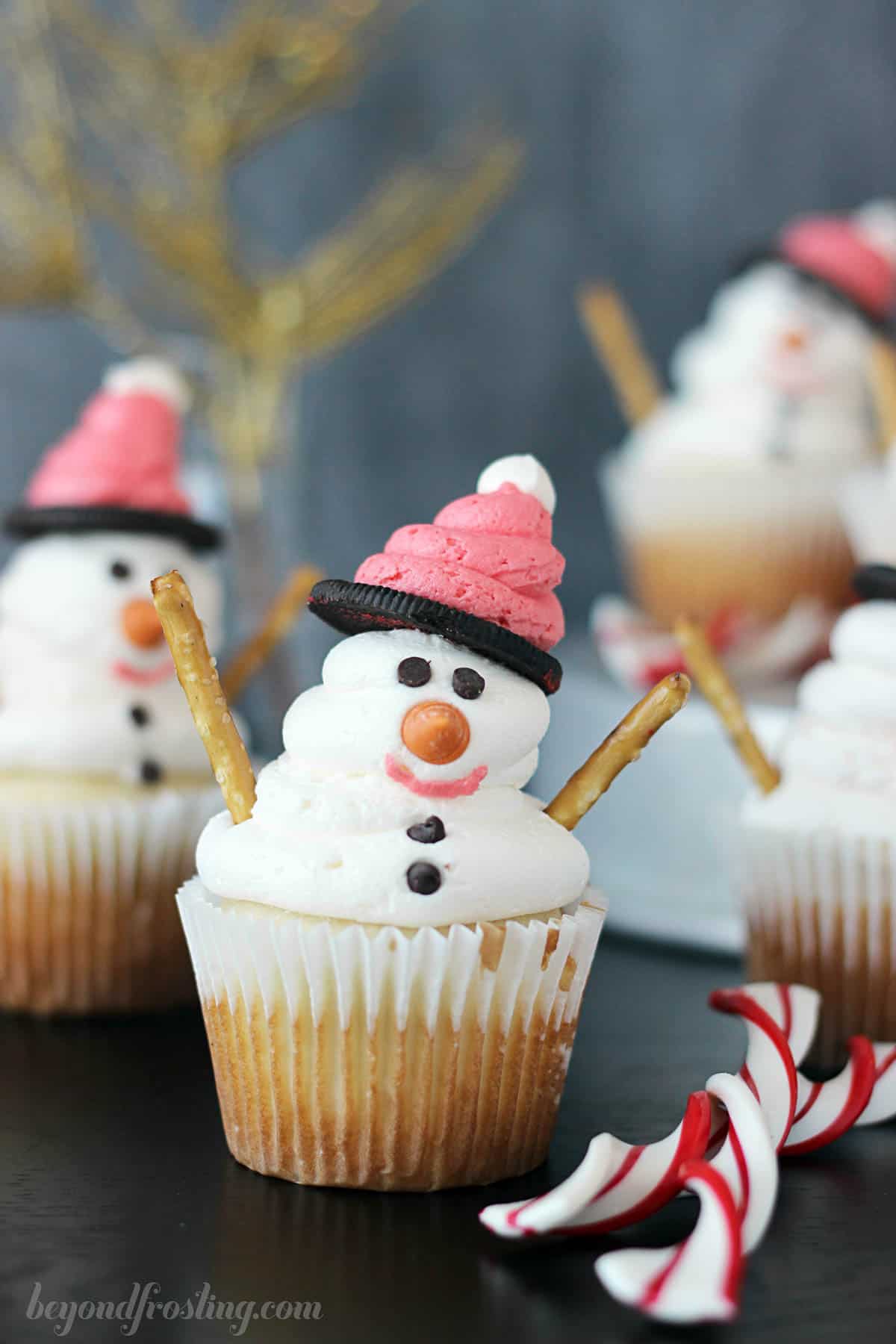 front view of a snowman cupcake with more cupcakes in the background