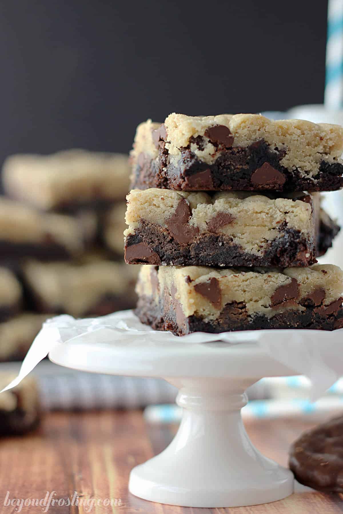 side view of three cookie bars stacked on a small cupcake stand