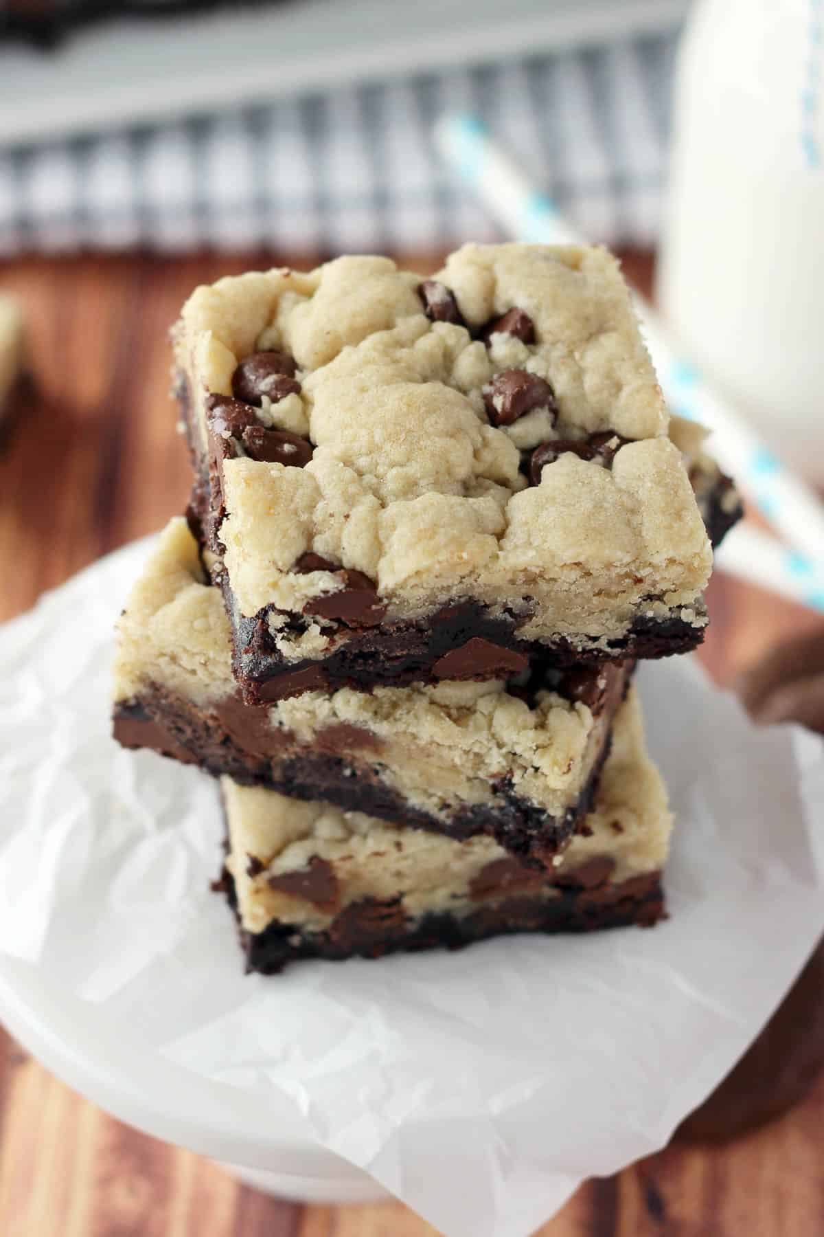 overhead of three cookie bars stacked on a piece of parchment paper