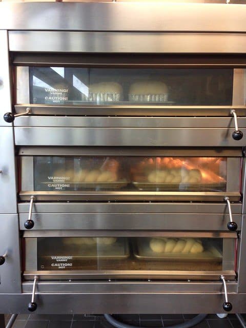 Braided loaves of bread being cooked in a commercial oven