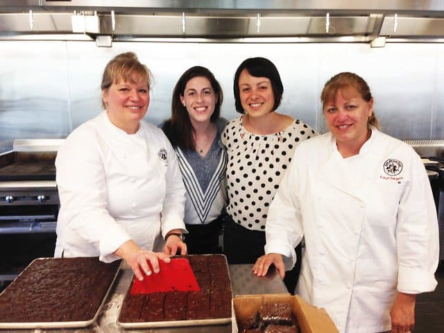 King Arthur Flour chefs with two bloggers in front of two pans of brownies