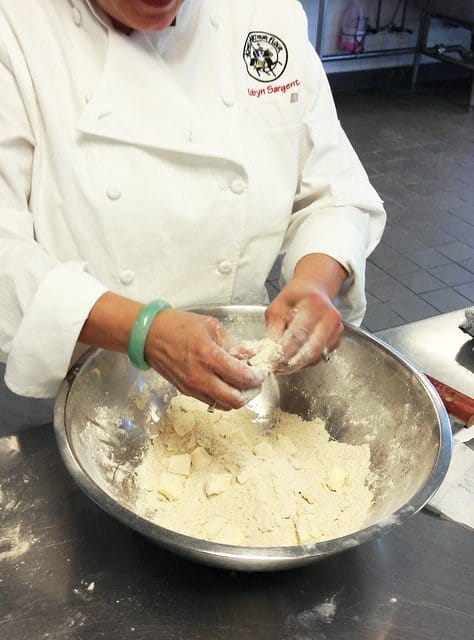 Chef Robyn demonstrating how to work dough with her hands