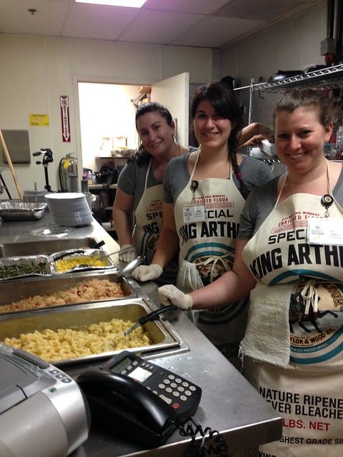 Three ladies serving dinner at a shelter