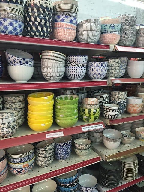 Shelves of colorful bowls at a store
