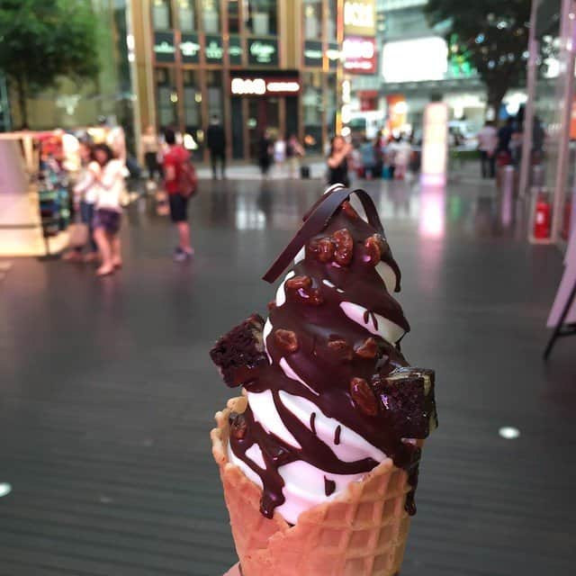 Close-up of ice cream in a waffle cone with chocolate sauce