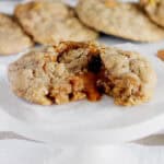 side view of an oatmeal cookie with caramel spilling out