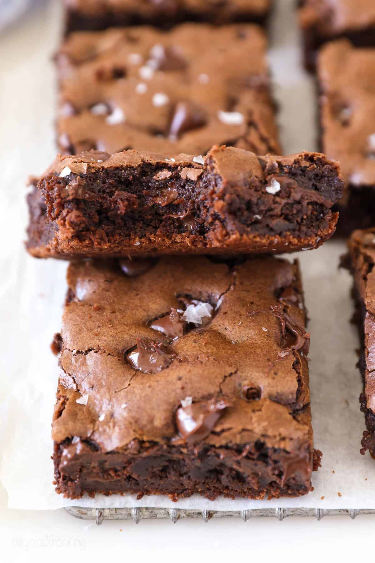 Overhead view of three cocoa powder brownies, one with a bite missing