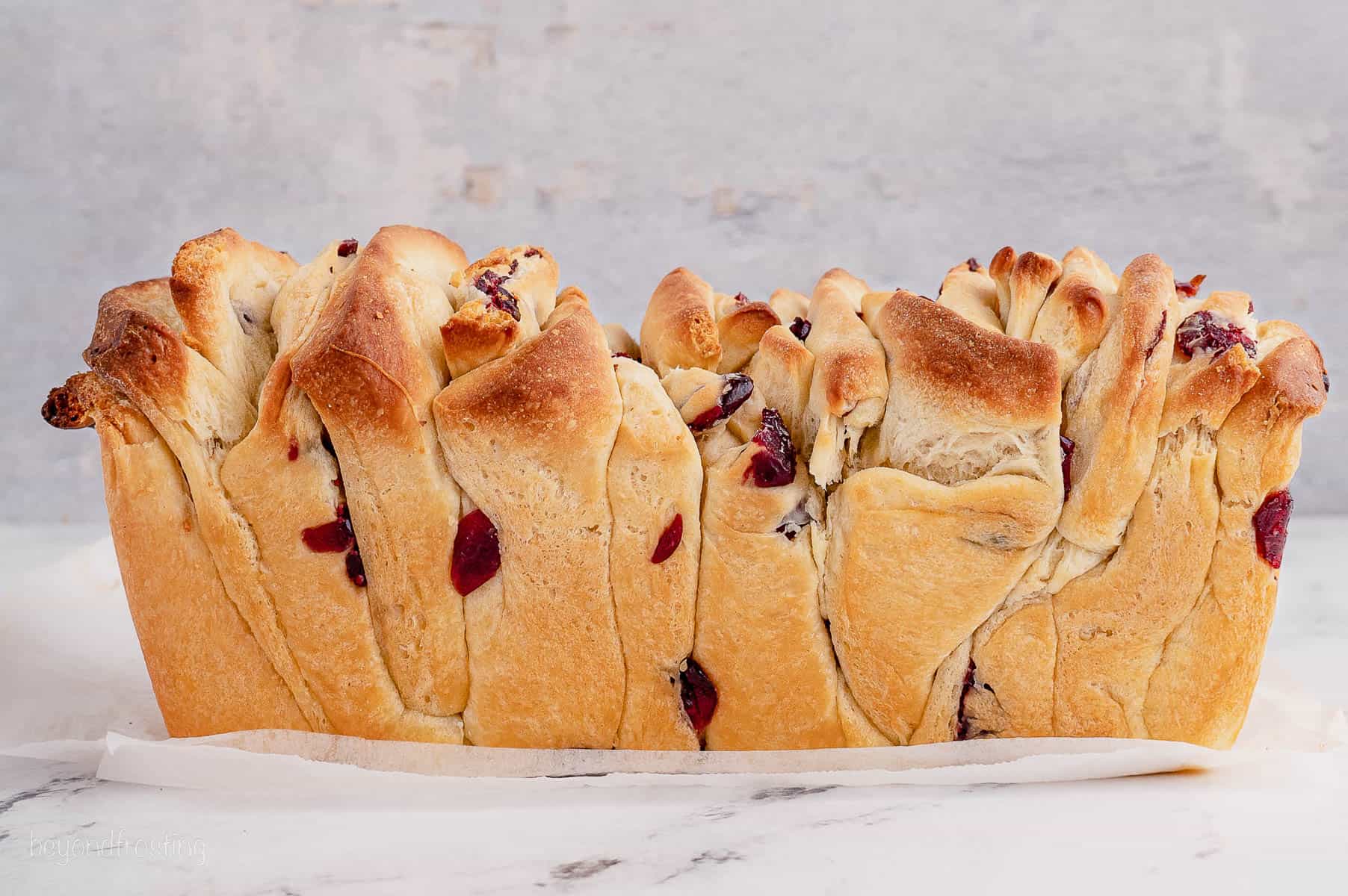 side view of a baked loaf of cranberry orange pull apart bread