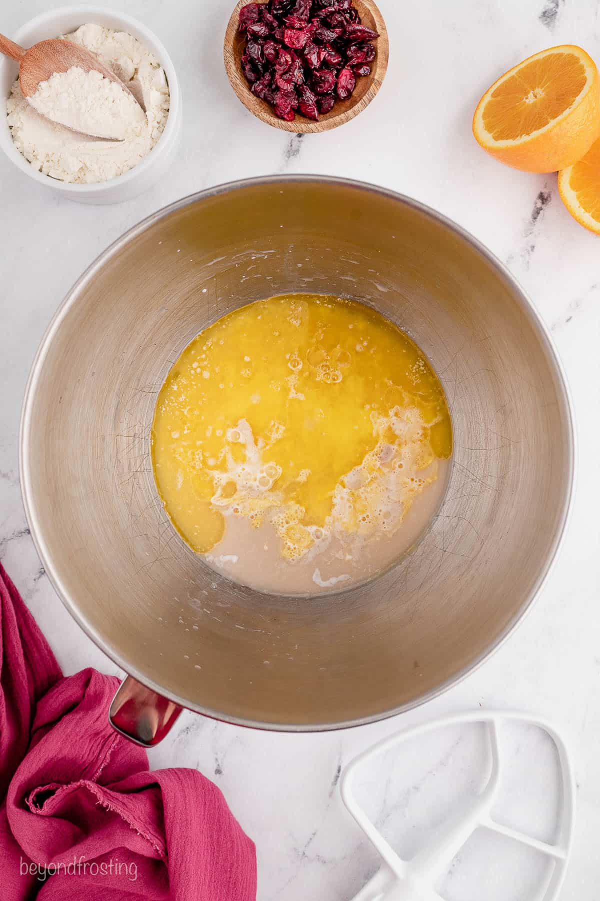 overhead of whisked eggs in a mixing bowl
