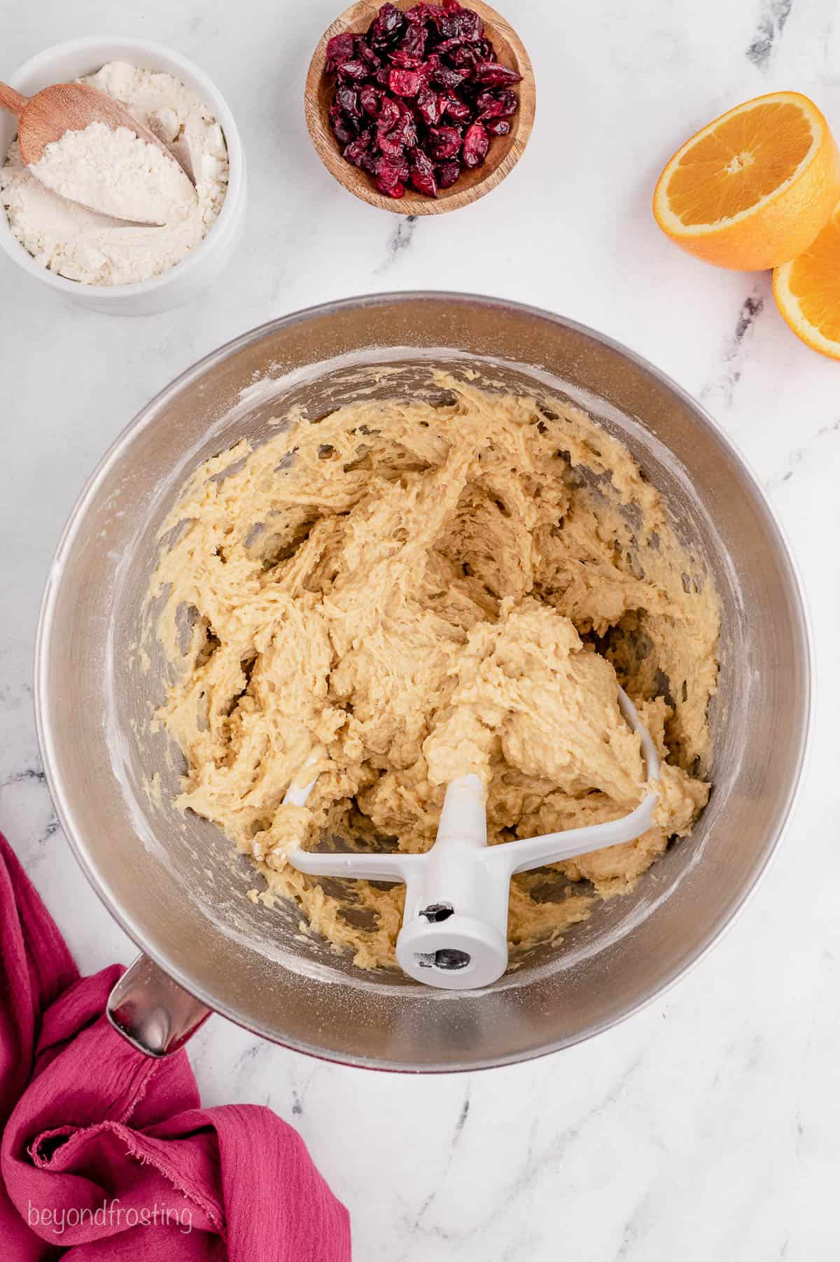 overhead of bread dough in a mixing bowl
