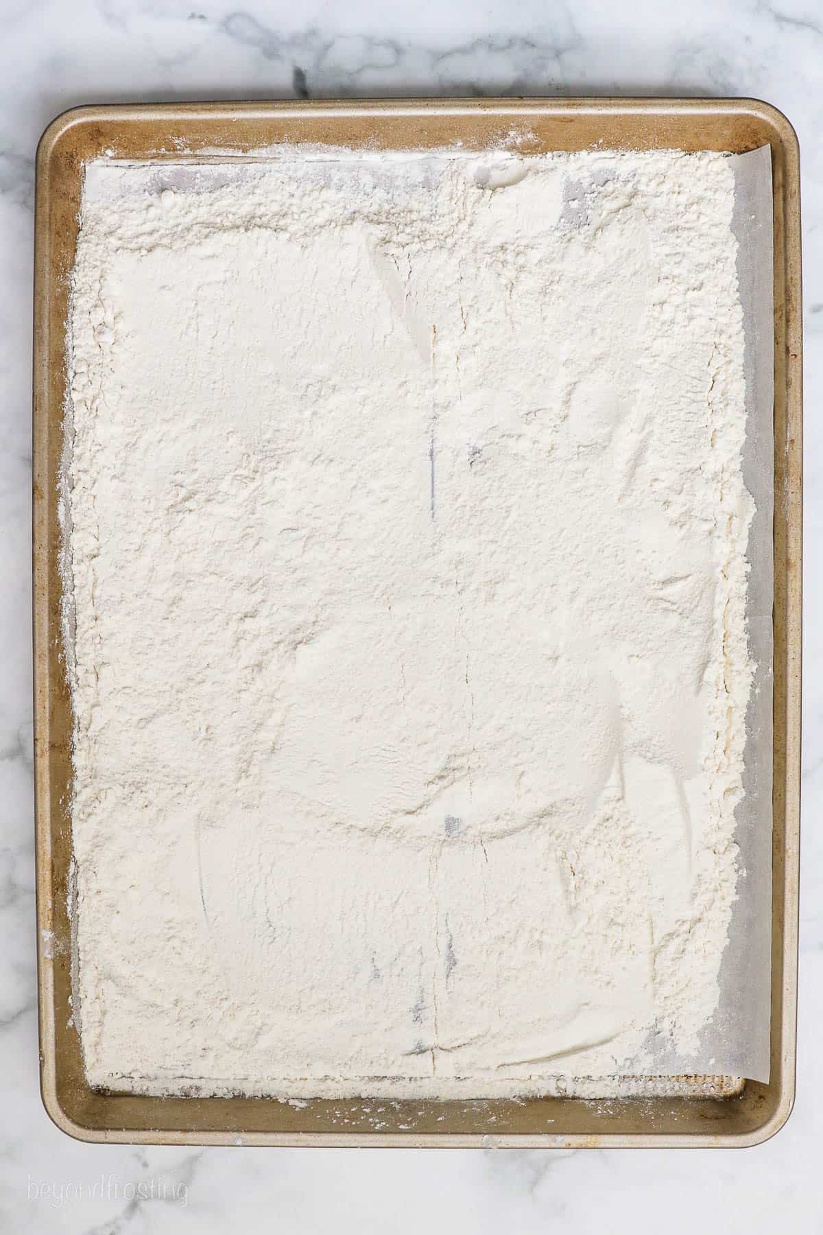 Flour spread out on a baking sheet