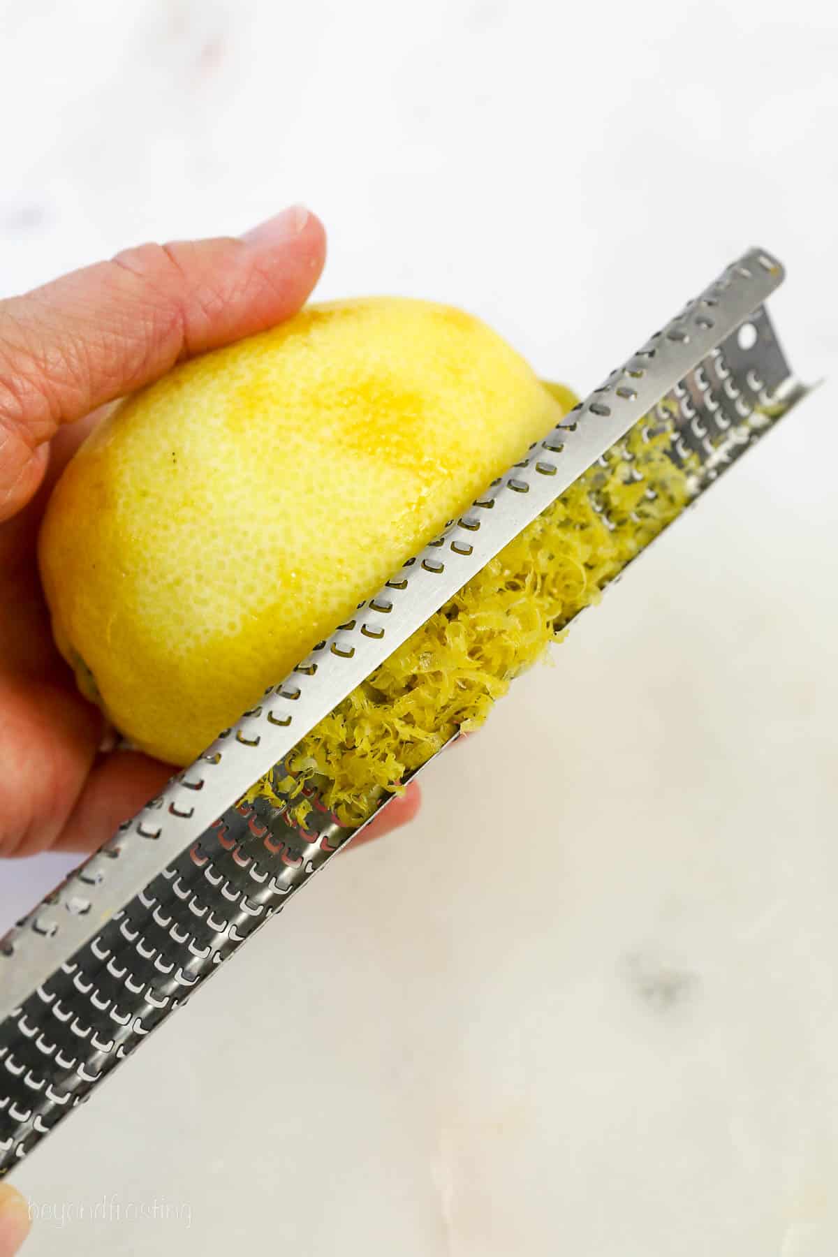 A lemon zester with a lemon