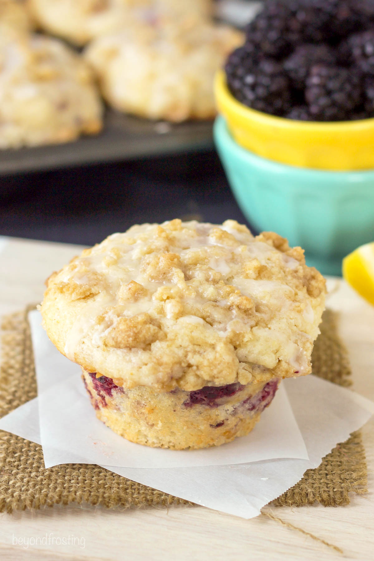 side view of a lemon blackberry muffin on a napkin