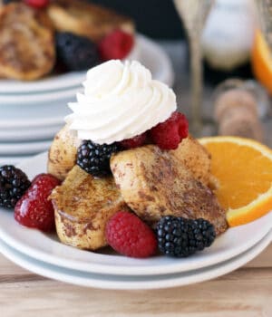 side view of a plate with french toast, whip, and fresh fruit