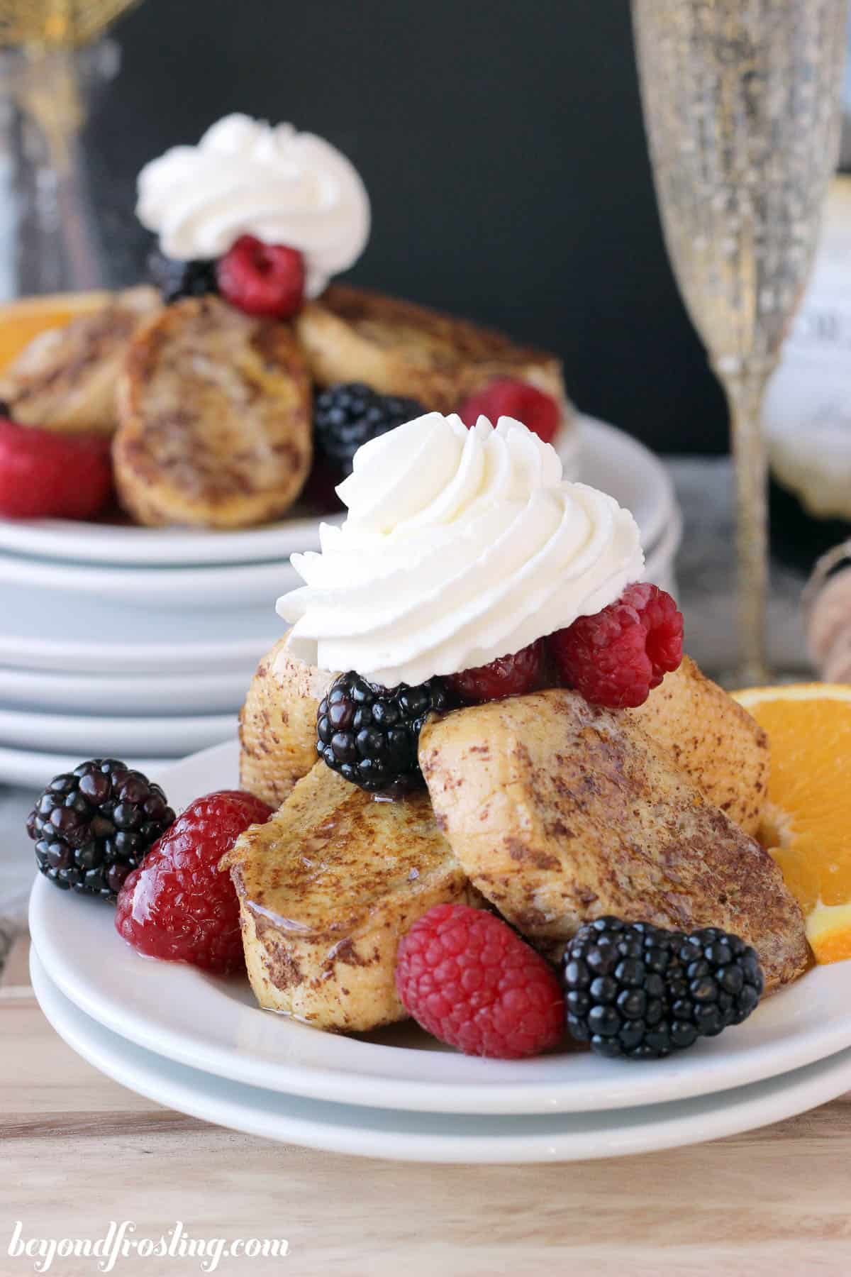 a pile of mimosa french toast with whip on a plate