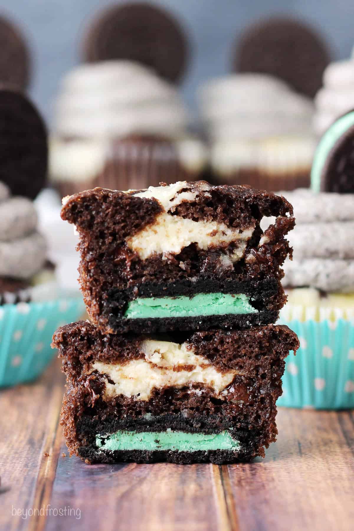 two halves of mint oreo cupcakes stacked to show the center of the cupcake