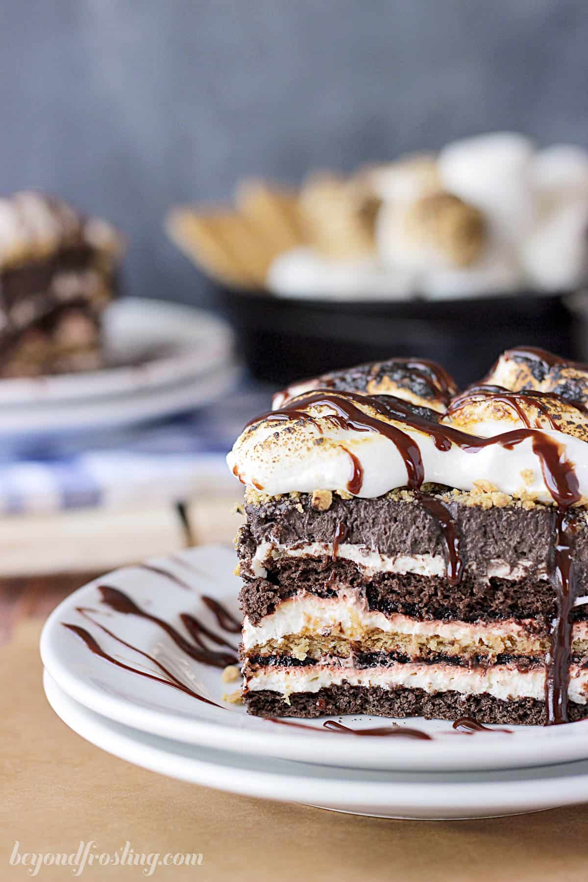 side view of a square of s'mores lasagna on a plate