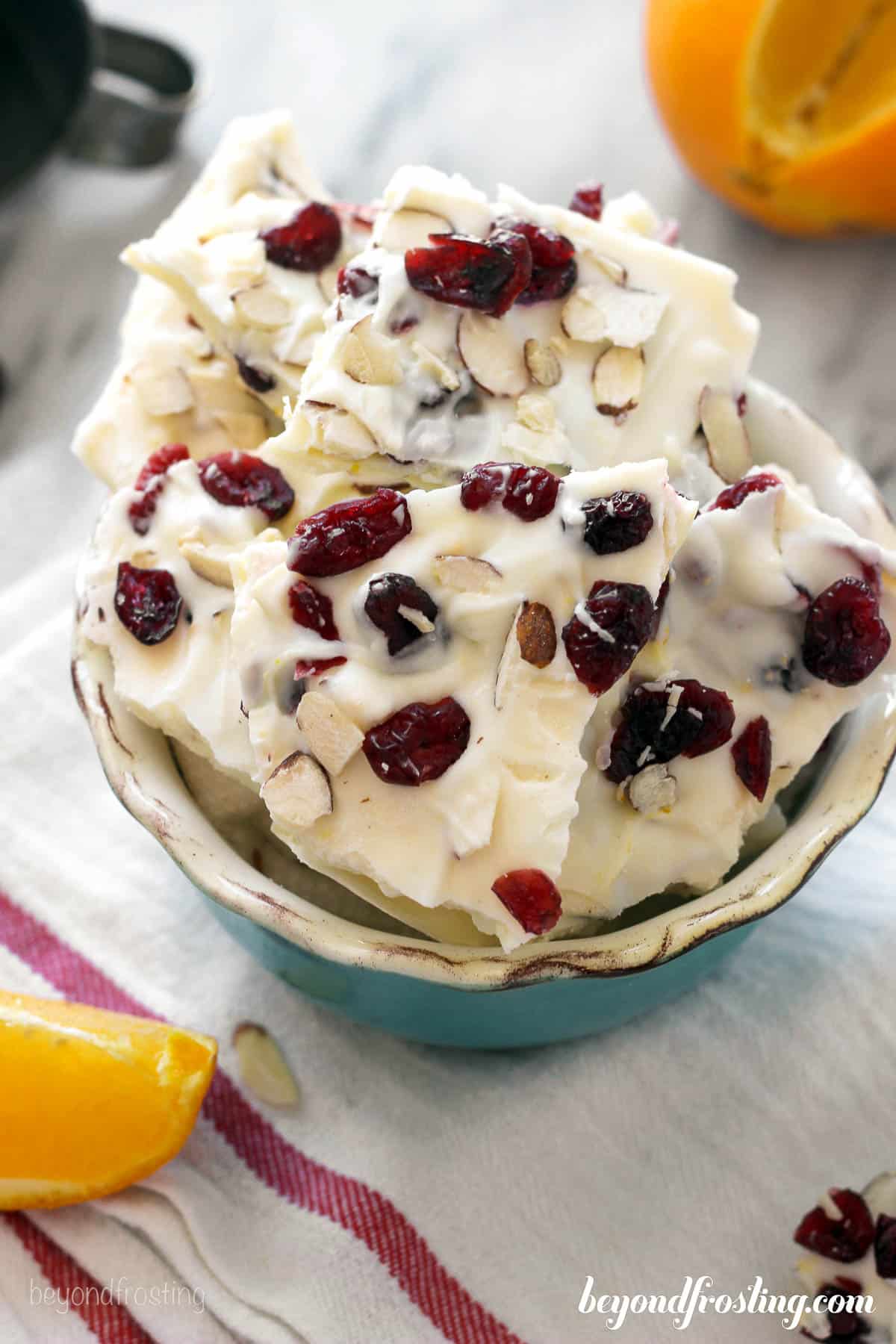 overhead of a bowl filled with orange cranberry almond bark