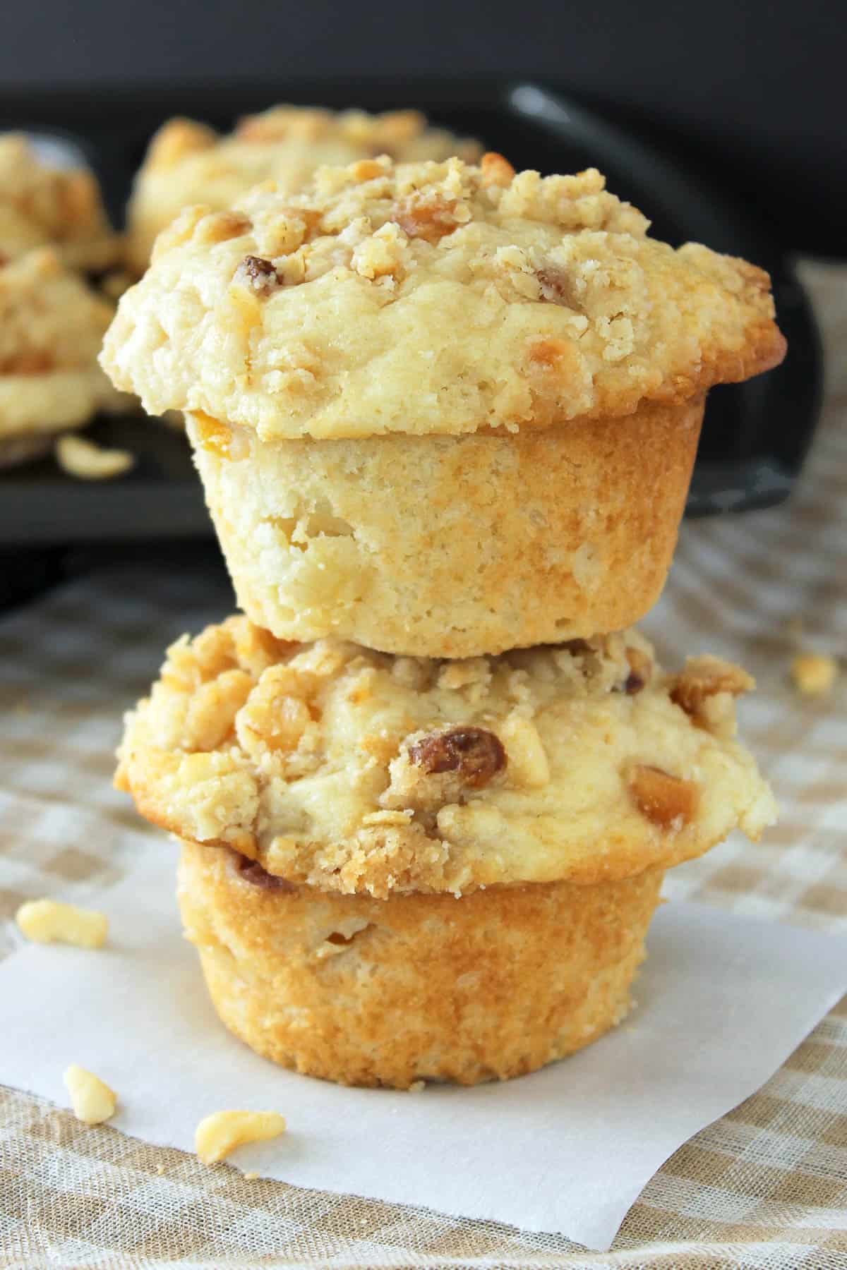 two peach muffins stacked