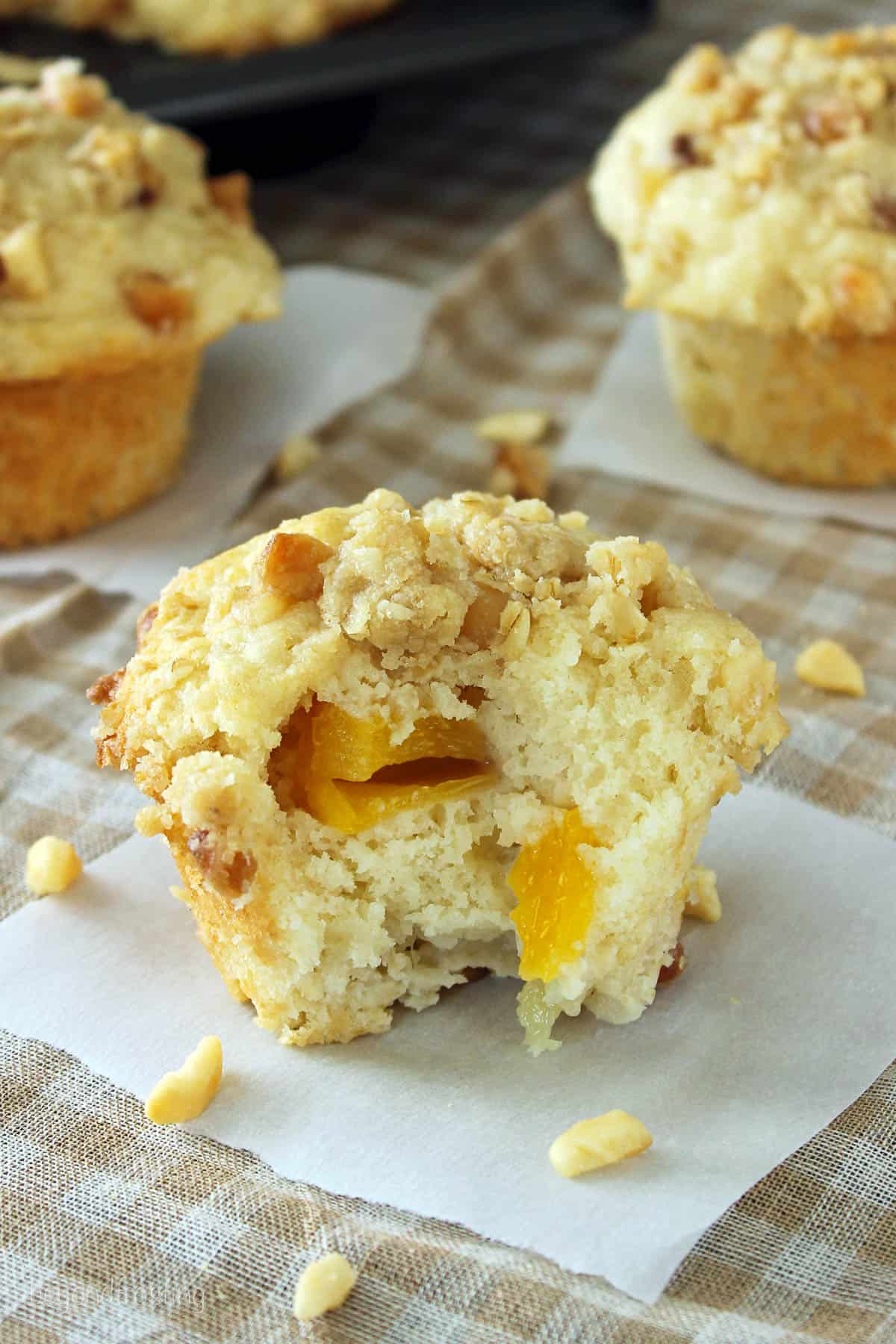a peach macadamia nut muffin with a bite taken out