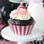 closeup of a peppermint chocolate cupcake on a cupcake stand