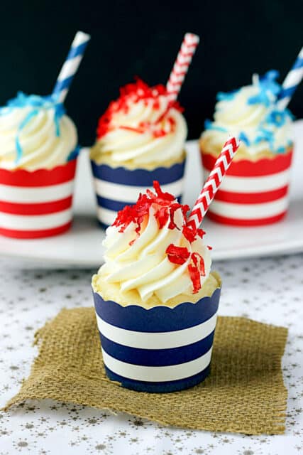 side view of a pineapple cupcake in a blue and white striped wrapper